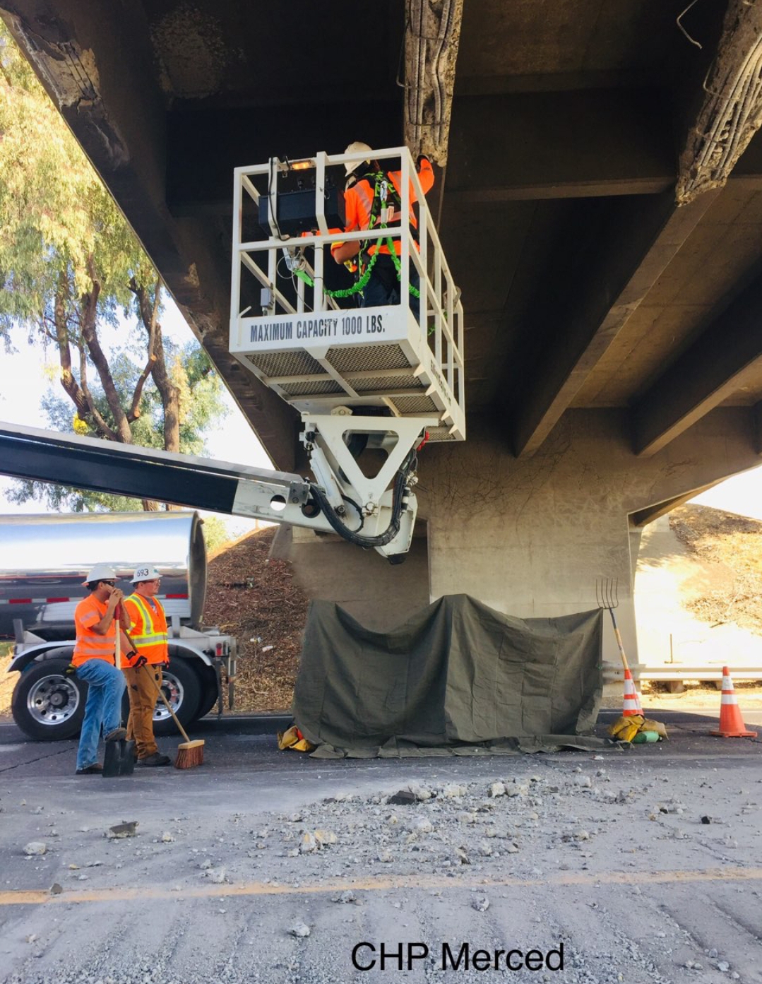 Flat bed semi truck carrying excavator hits bridge in Atwater
