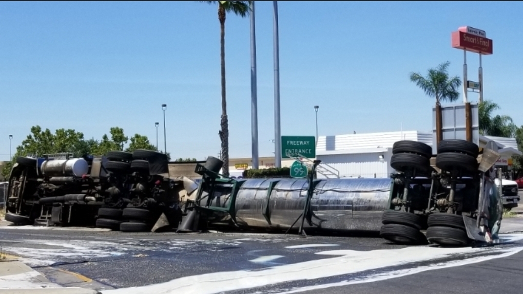 Big rig overturns in Merced, spills several gallons of milk